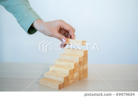 Businesswoman hand holding blocks wood game, Concept Risk of management and strategy plan, growth business success process and team work 69979684