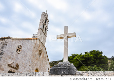 Christian cross on the waterfront of Vis island, Croatia 69980385