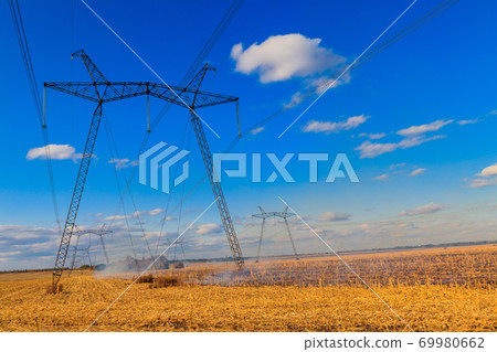 High voltage power line against blue sky High voltage power line against blue sky 69980662