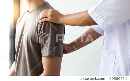 Professional therapists are stretching muscles, patients with abnormal muscular symptoms, physical rehabilitation therapies and treatment of physiological disorders by physiotherapists concept. Professional therapists are stretching muscles, patients with abnormal muscular symptoms, physical rehabilitation therapies and treatment of physiological disorders by physiotherapists concept. 69980734