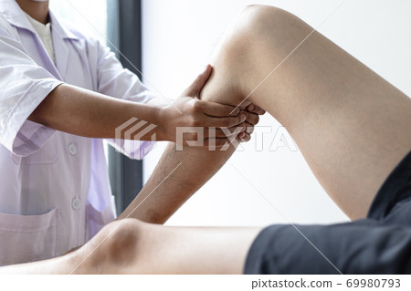Professional therapists are stretching muscles, patients with abnormal muscular symptoms, physical rehabilitation therapies and treatment of physiological disorders by physiotherapists concept. Professional therapists are stretching muscles, patients with abnormal muscular symptoms, physical rehabilitation therapies and treatment of physiological disorders by physiotherapists concept. 69980793