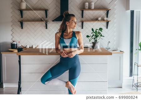 Portrait of a young athletic woman in the kitchen 69980824