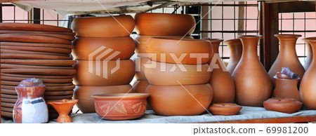 Shelves with ceramic dishware. Wide photo. Shelves with ceramic dishware. Wide photo. 69981200