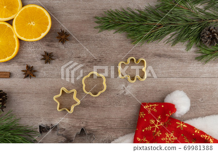 preparing festive treats for Christmas and new year holidays. cookie molds and flour. orange and star anise.  69981388