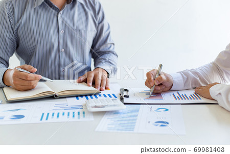 Business team meeting analyze financial graphs market growth reports And corporate income tax, Analysis of financial accounting and real estate investment concept. Business team meeting analyze financial graphs market growth reports And corporate income tax, Analysis of financial accounting and real estate investment concept. 69981408