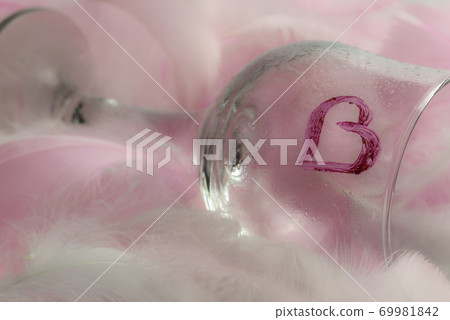 Close-up view of a lying glass in feathers 69981842