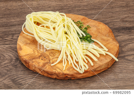 Chechil spaghetti cheese over board Chechil spaghetti cheese over board 69982095