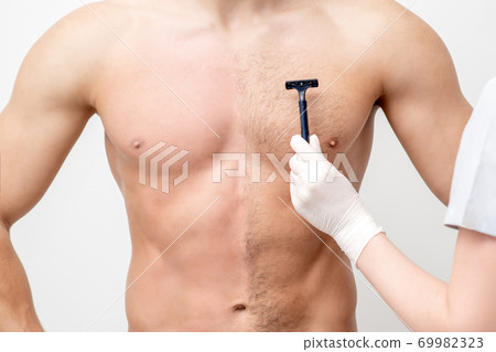 Beautician shaves chest of young man 69982323