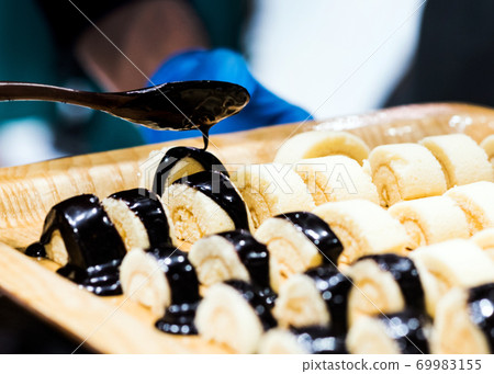 Chef cooking, Chef preparing food in the kitchen, Chef decorating dish, closeup. 69983155