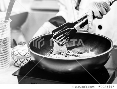 Chef cooking, Chef preparing food in the kitchen, Chef decorating dish, closeup. Chef cooking, Chef preparing food in the kitchen, Chef decorating dish, closeup. 69983157