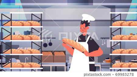 male baker in uniform holding bread bakery products baking manufacture concept portrait male baker in uniform holding bread bakery products baking manufacture concept portrait 69983278