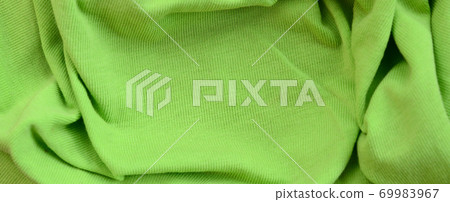 The texture of the fabric is bright green. Material for making shirts and blouses 69983967