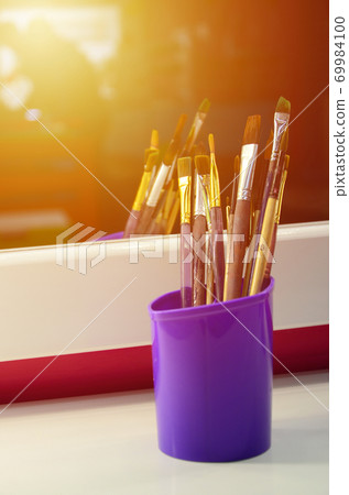 Art paint brushes in cup are located in the children's entertainment hall at the mirror Art paint brushes in cup are located in the children's entertainment hall at the mirror 69984100