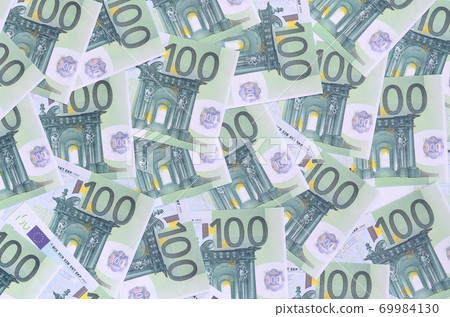Background pattern of a set of green monetary denominations of 100 euros. A lot of money forms an infinite heap Background pattern of a set of green monetary denominations of 100 euros. A lot of money forms an infinite heap 69984130