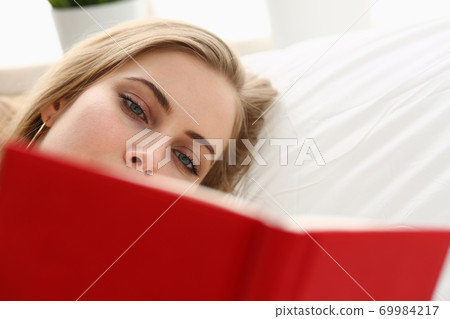woman read book stay in bed woman read book stay in bed 69984217