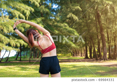 Asian sporty woman work out and stretching in morning 69984331