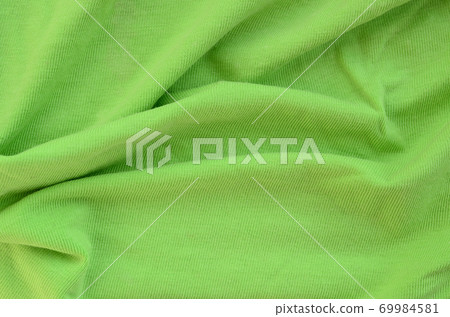 The texture of the fabric is bright green. Material for making shirts and blouses The texture of the fabric is bright green. Material for making shirts and blouses 69984581