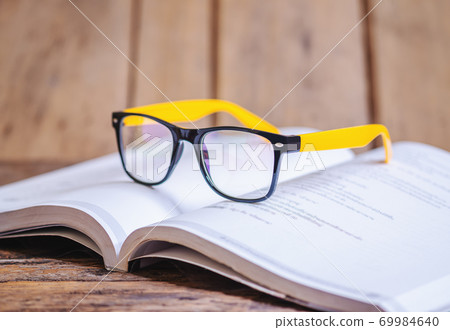 Glasses on the book blurred background 69984640