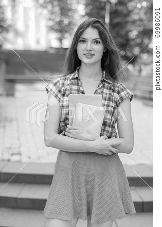 Girl student in skirt and plaid shirt. Black and white photo. BW 69986091
