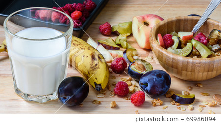 Muesli with sweet berries, fruits and milk Muesli with sweet berries, fruits and milk 69986094