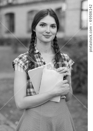 Girl student in skirt and plaid shirt. Black and white photo. BW Girl student in skirt and plaid shirt. Black and white photo. BW 69986142