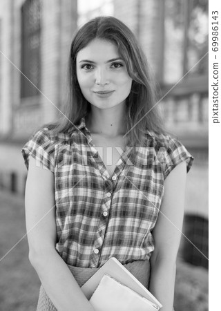 Girl student in skirt and plaid shirt. Black and white photo. BW Girl student in skirt and plaid shirt. Black and white photo. BW 69986143