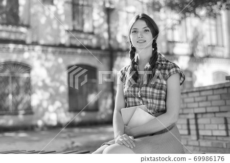 Young girl student on a bench. Black and white photo. BW Young girl student on a bench. Black and white photo. BW 69986176