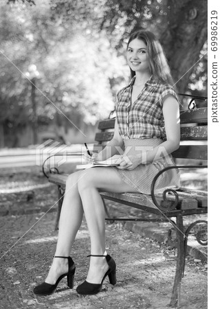 Young girl student on a bench. Black and white photo. BW 69986219
