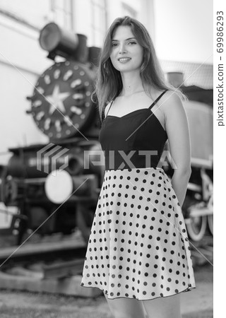 Girl in a white-black dress with polka dots. Black and white photo. BW Girl in a white-black dress with polka dots. Black and white photo. BW 69986293