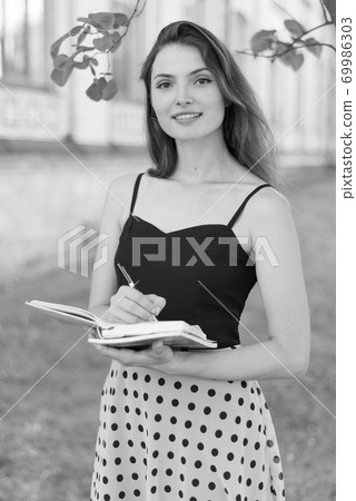 Young girl student in dress. Black and white photo. BW 69986303