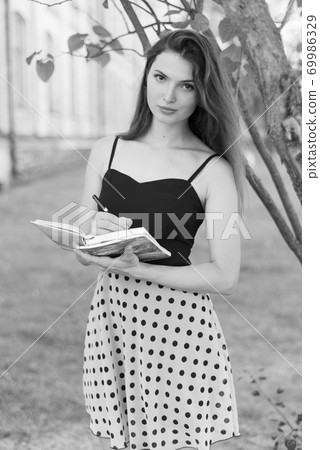 Young girl student in dress. Black and white photo. BW 69986329