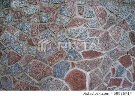 Background wall of red and gray granite pieces of stones fastened with cement Background wall of red and gray granite pieces of stones fastened with cement 69986714