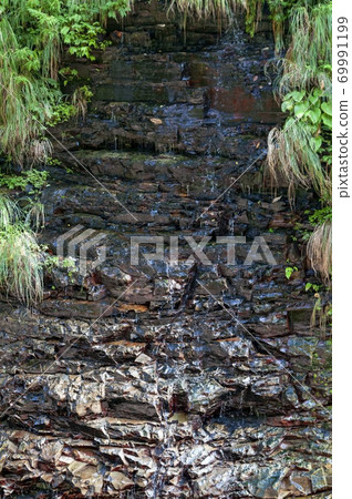 Wet rock walls and grass Wet rock walls and grass 69991199