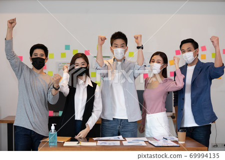 Group of Happy Asian business men leader standing smile celebrating confidence with Business team at Co-Working space,Small Business Startup Concept Group of Happy Asian business men leader standing smile celebrating confidence with Business team at Co-Working space,Small Business Startup Concept 69994135