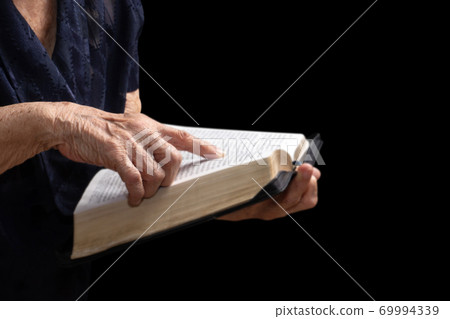 old women reading from the holy bible, close up old women reading from the holy bible, close up 69994339