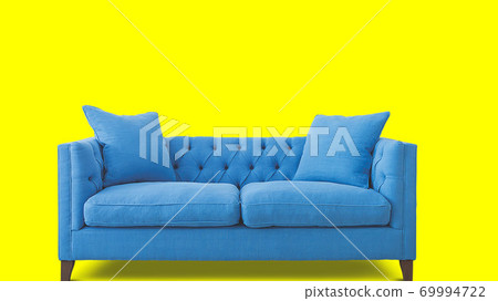 blue sofa isolated on yellow background blue sofa isolated on yellow background 69994722