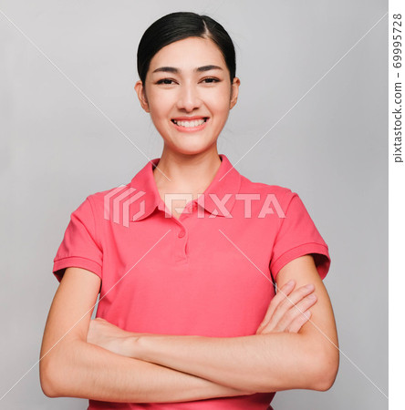 young beautiful asian woman wore pink t shirt, Showed smile and smart  expression , on gray background 69995728