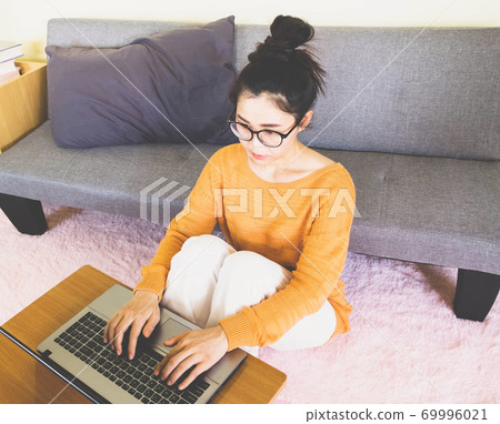 soft selective focus young beautiful asian woman wore orange knitwear,sitting on gray sofa,work online lifestyle,relax at home with coffee,home working laptop,work from home soft selective focus young beautiful asian woman wore orange knitwear,sitting on gray sofa,work online lifestyle,relax at home with coffee,home working laptop,work from home 69996021