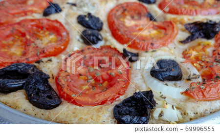 Italian focaccia bread with tomatoes, onions and olives  69996555