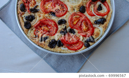 Italian focaccia bread with tomatoes, onions and olives Italian focaccia bread with tomatoes, onions and olives 69996567