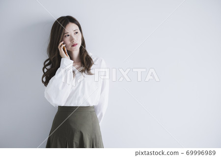 Woman using a smartphone Woman using a smartphone 69996989