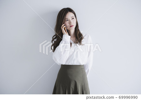 Woman using a smartphone Woman using a smartphone 69996990