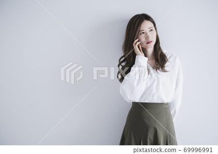 Woman using a smartphone Woman using a smartphone 69996991