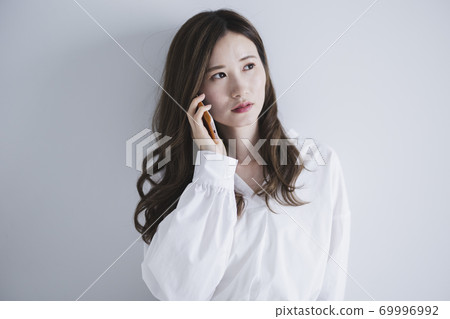 Woman using a smartphone Woman using a smartphone 69996992