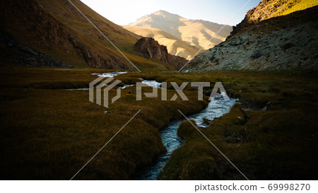 Sunset view to Tash-Rabat river and valley in Naryn province, Kyrgyzstan Sunset view to Tash-Rabat river and valley in Naryn province, Kyrgyzstan 69998270