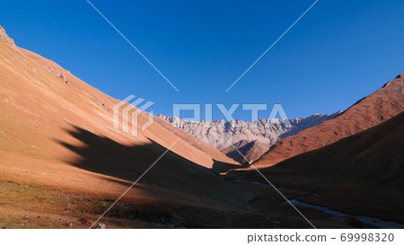 Sunset view to Tash-Rabat river and valley in Naryn province, Kyrgyzstan 69998320