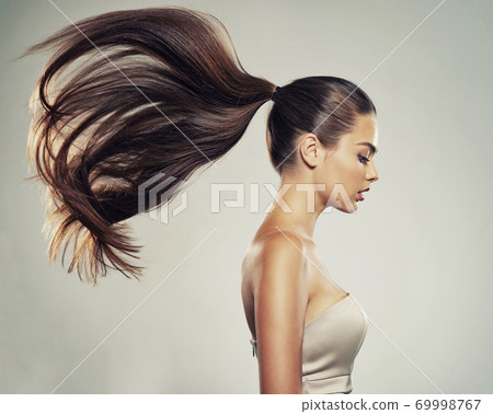 Profile portrait of a beautiful woman with a long straight hair. Profile portrait of a beautiful woman with a long straight hair. 69998767