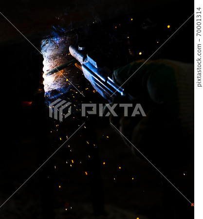 Flame of fire and sparks from welding metal at night Flame of fire and sparks from welding metal at night 70001314