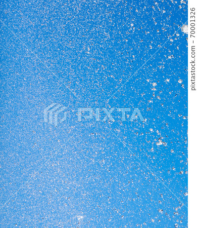 Splashes of water against the blue sky Splashes of water against the blue sky 70001326