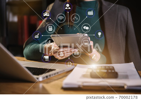 Business women or accountant working on laptop computer with business document, graph diagram and calculator on office table in office. Business women or accountant working on laptop computer with business document, graph diagram and calculator on office table in office. 70002178